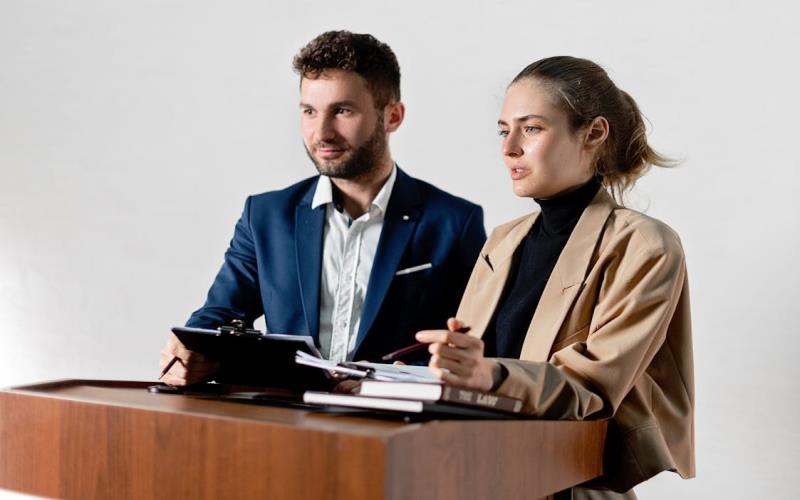 Woman Discussing Documents while at the Podium